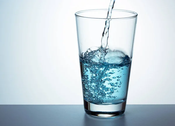 Glass of fresh blue water — Stock Photo, Image