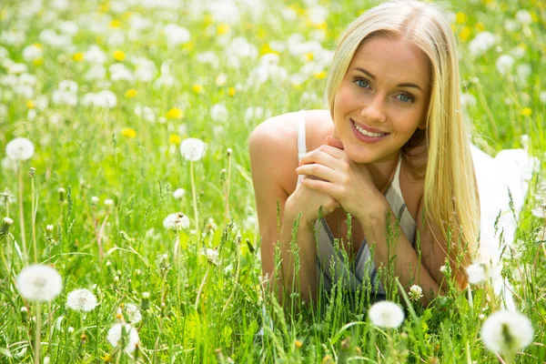 Young woman among the flowers — Stock Photo, Image