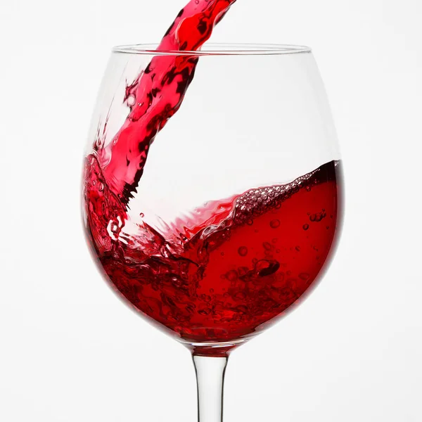 Beautiful splash of red wine in a glass — Stock Photo, Image