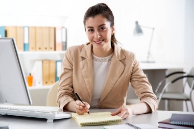 Young business woman using computer at office