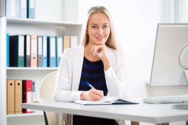 Young business woman using computer at office