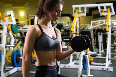 kadın dumbbells ile egzersiz yaparak 