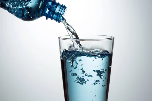 Pouring water from bottle — Stock Photo, Image