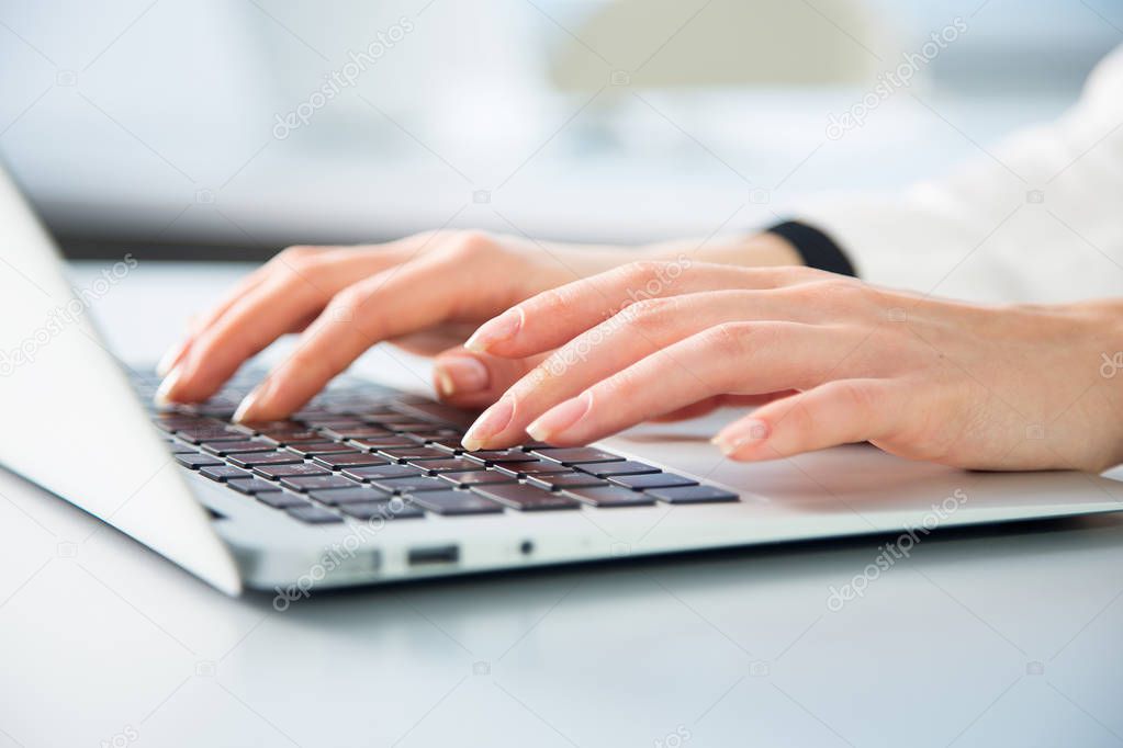 Business woman typing on laptop 
