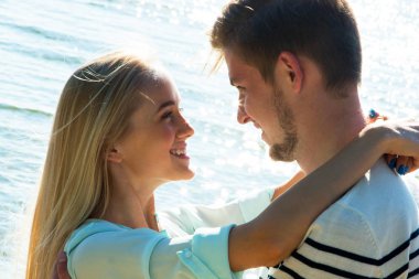 Genç bir çift sahilde yürüyor.