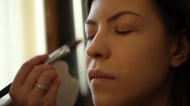 Yüzünde kozmetik ton Vakfı uygulanması makyaj sanatçısı. 