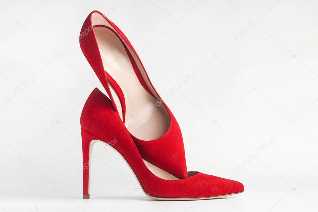 Closeup of red high heels on white background