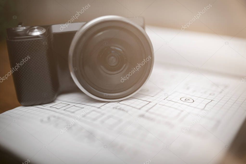 Digital camera on notepad with storyboard