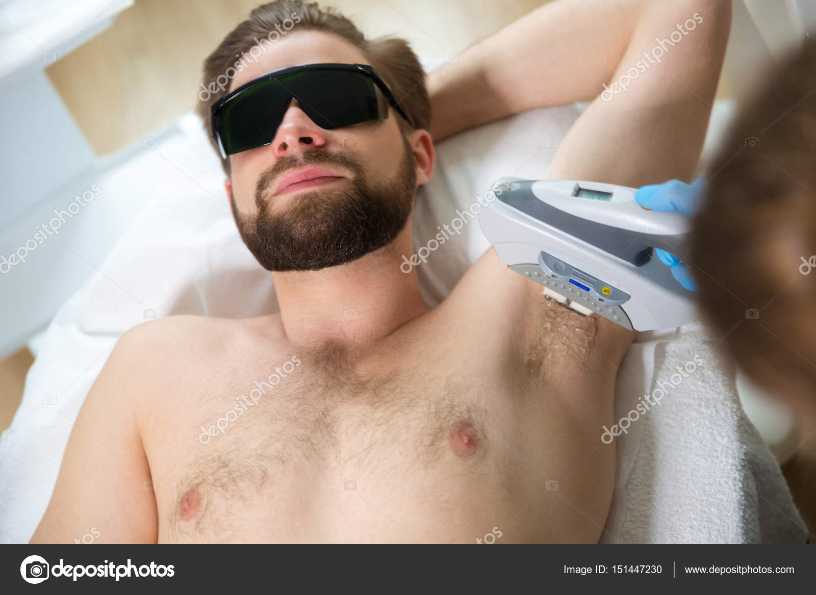 Men lying at beauticians during laser armpit hair removal therapy Stock  Photo  Alamy