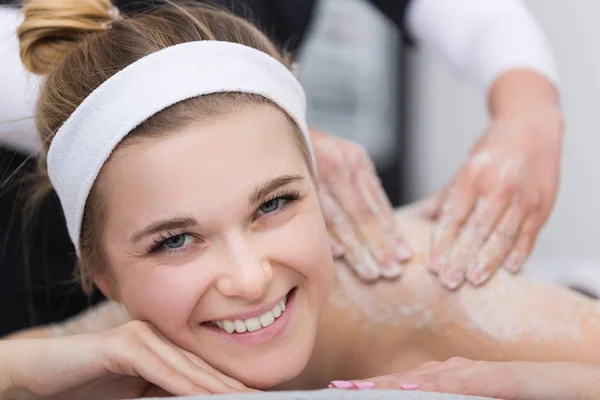 Woman getting exfoliating salt scrub massage at beautician's — Stock Photo, Image