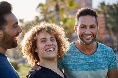 Yakışıklı adam dışarıda gülümseyen arkadaşlarıyla ayakta