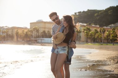 Mutlu adam sahil kız kucaklayan