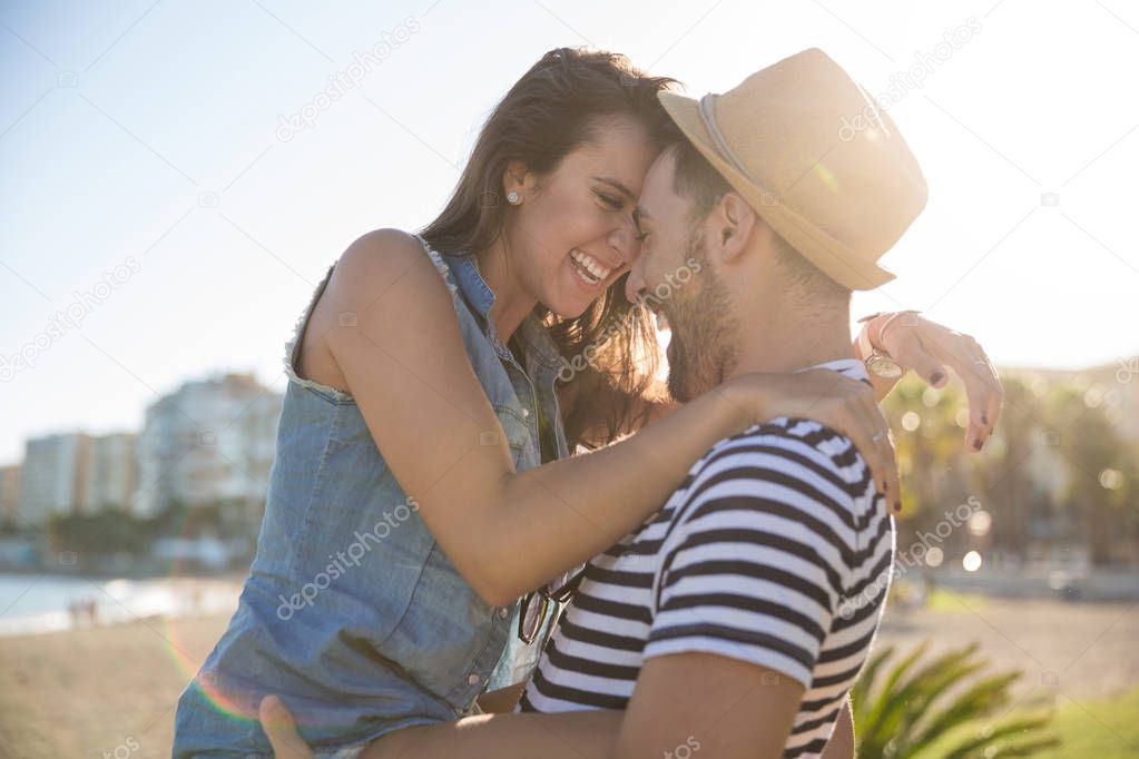 Happy woman leaning her forehead against her boyfriend