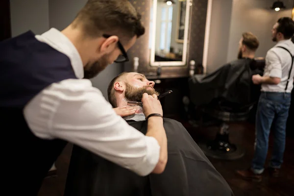 Peluquero afeitado joven con afeitadora — Foto de Stock