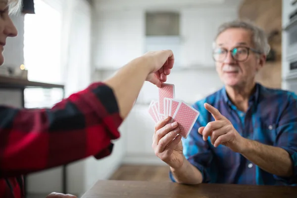 Feliz pareja de ancianos jugando a las cartas juntos — Foto de Stock