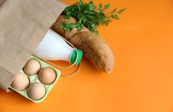 online shopping, food eggs, milk, bread, loaf and fruit in a paper bag