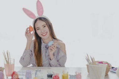 Bunny girl with easter eggs with blurred white  background
