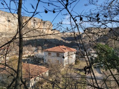 Çatı kiremitleri olan birkaç antik ev, cadde bir dağın üzerinde duruyor.