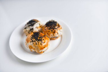 Çin fasulye ezmeli kekleri seramik tabakta, beyaz arka planda izole edilmiş.