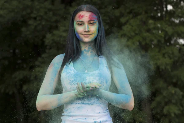 Lovely brunette woman with powder Holi on her face — Stock Photo, Image