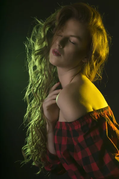 Donna con lunghi capelli ondulati e luce verde — Foto Stock