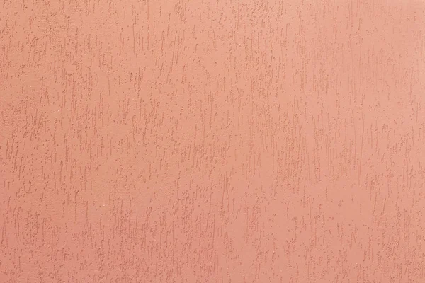 Pink decorative relief plaster on wall. Closeup shot