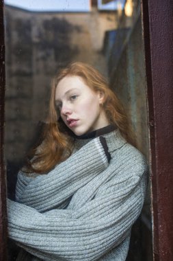 Eski cam doo arkasında çilli güzel kızıl saçlı modeli