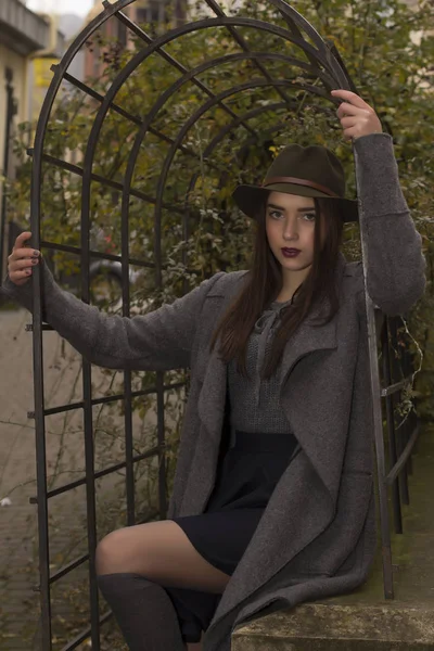 Femme brune à la mode en chapeau et manteau — Photo