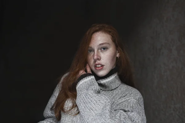 Smyslný mladý model s pihami pózujícími v tmavé místnosti — Stock fotografie