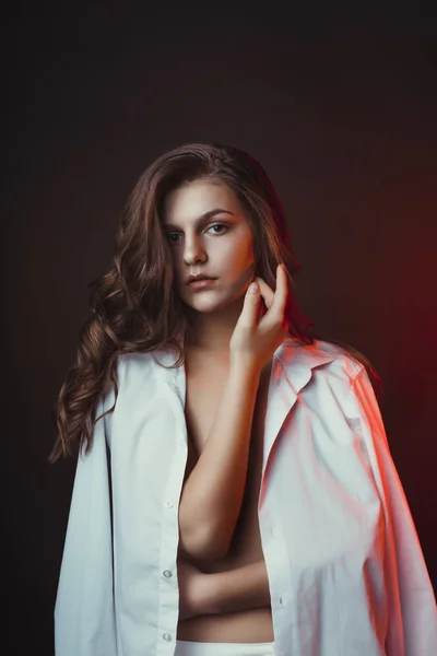 Sexy young woman wearing men's shirt at studio — Stock Photo, Image