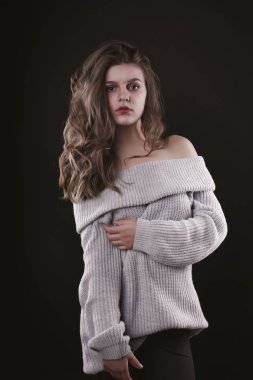 Muhteşem genç kadın kazak çıplak omuz ile poz