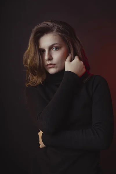 Underbara unga kvinna poserar i tröja i skuggorna — Stockfoto