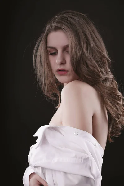 Glamor young lady posing in a white men's shirt — Stock Photo, Image