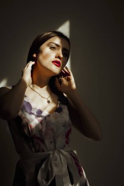 Sihir güneş ışınlarının poz şık elbiseli esmer Bayan