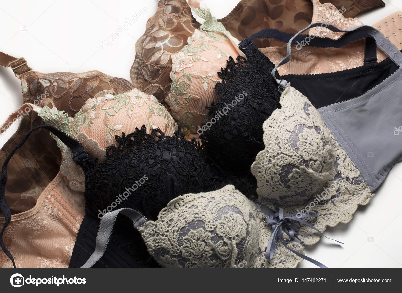 Stack of different lace sexy bras over a white background Stock