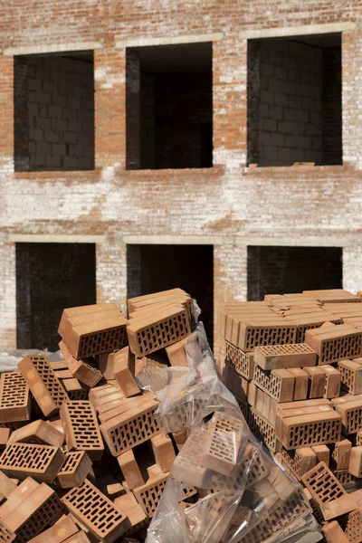 Stack of perforated bricks covered polyethylene