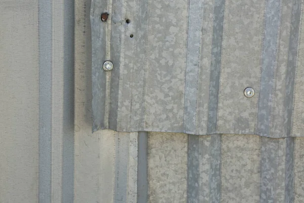 Corrugated metal sheet with a bolt — Stock Photo, Image