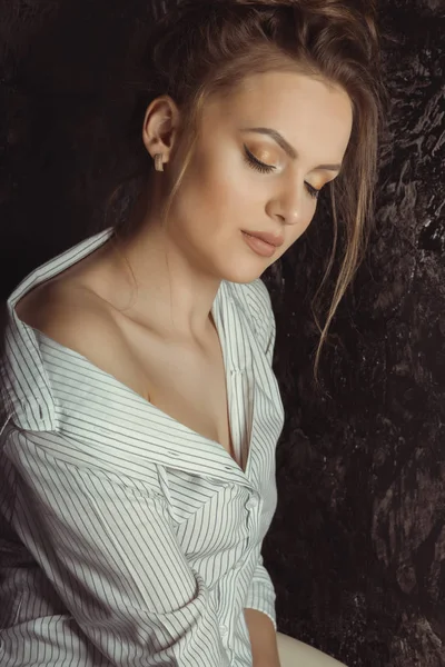 Tender young model in shirt posing at studio with closed eyes — Stock Photo, Image