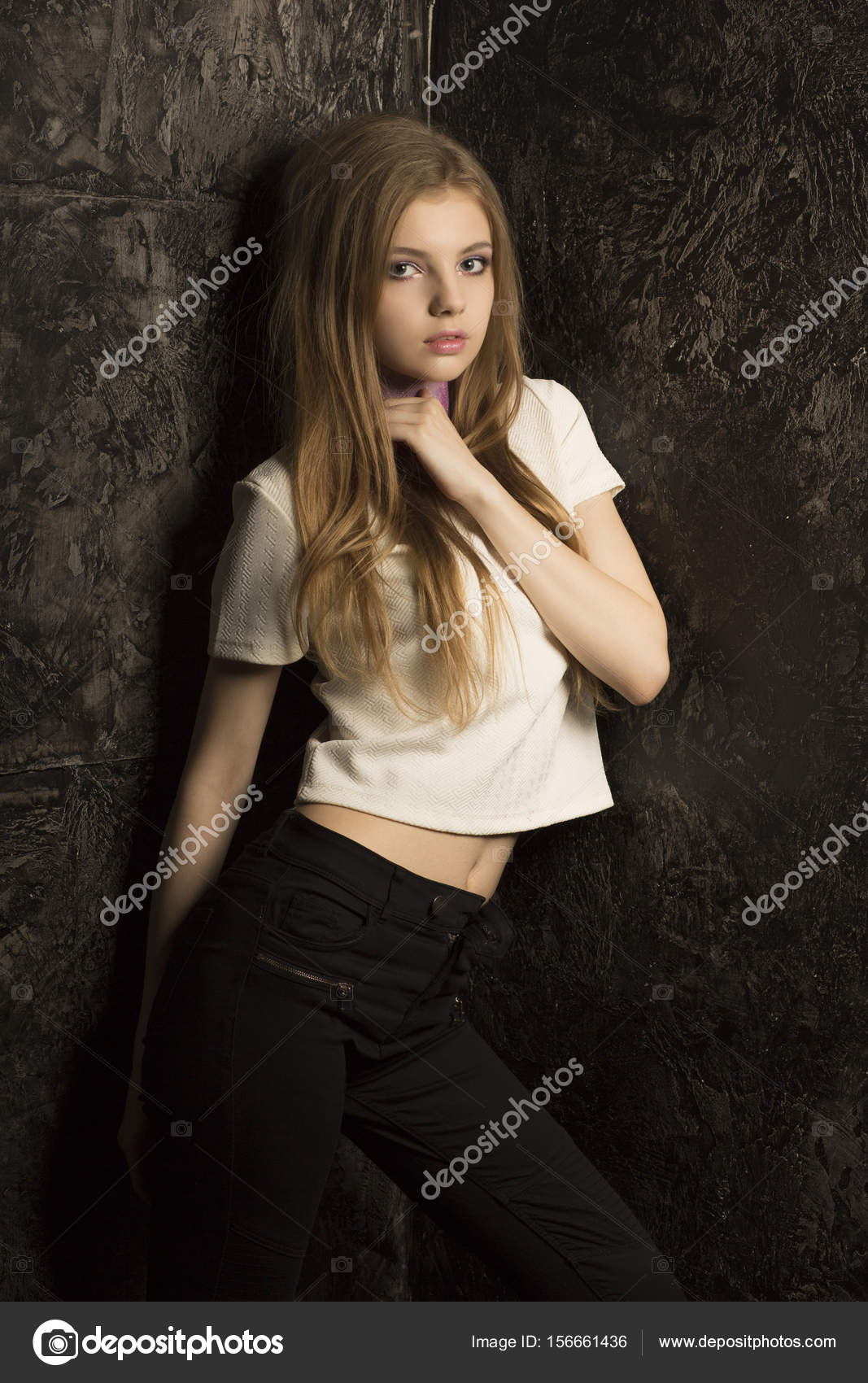 Pretty Young Lady With Long Blonde Hair Posing In Dark Room