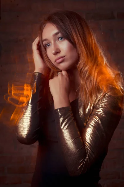Luksusowy model brunetka w złoto srebrna kurtka i niebieskie dżinsy. M — Zdjęcie stockowe