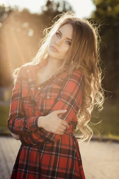 Estilo de vida retrato de jovem modelo posando no parque em raios de — Fotografia de Stock