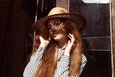Çekici genç kırmızı saçlı model o gölge ile hasır şapkalı