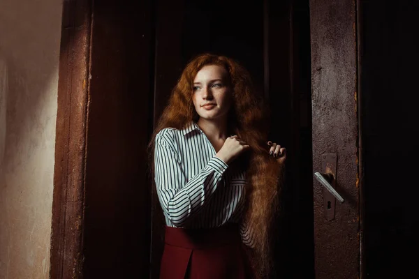 Lovely young red haired model with long lush hair. Woman posing — Stock Photo, Image