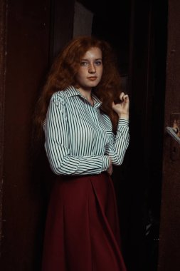 Muhteşem genç kırmızı saçlı modelinde stripred gömlek ve kırmızı etek 