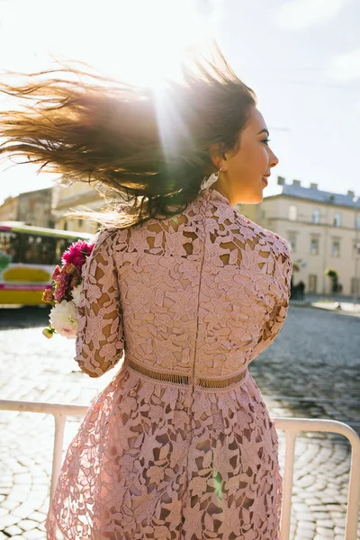 Pretty brunette model wearing pink dress with hair on wind — Stock Photo, Image
