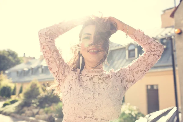 Beautiful smiling woman in lace dress looking at you. Vintage to