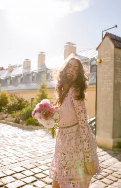 Çekici genç model ışınları o poz dantel pembe elbise