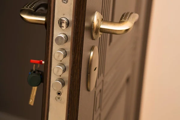 Closeup shot of modern door lock with a key. Empty space — Stock Photo, Image