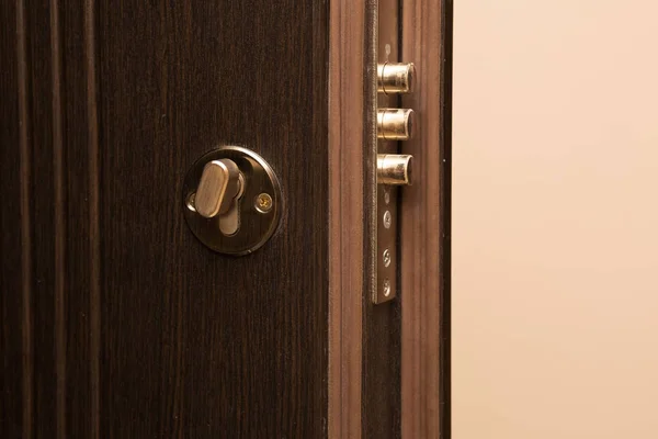 Contemporary metal door with a lock closeup — Stock Photo, Image