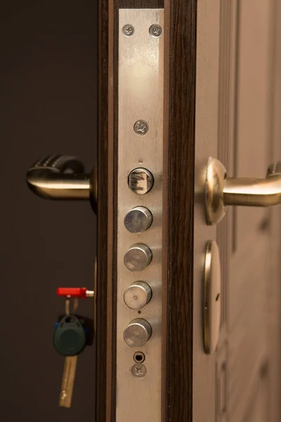 Modern metal and wood door with a lock — Stock Photo, Image